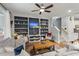 Cozy living room featuring custom built-in shelving, a ceiling fan, and comfortable seating at 1992 Kings Gate Ln, Mount Pleasant, SC 29466