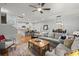 Open-concept living room showcases stylish furnishings, hardwood floors, and seamless flow to the kitchen and dining area at 1992 Kings Gate Ln, Mount Pleasant, SC 29466