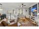 Cozy living room with hardwood floors, a ceiling fan, couches, and custom built-in shelving at 1992 Kings Gate Ln, Mount Pleasant, SC 29466