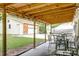 View of outdoor covered patio, garage and green backyard with a trailer and boat parked on the side at 203 Red Fox Run, Summerville, SC 29485