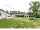 Spacious backyard with well-maintained lawn, fire pit, detached garage, and covered patio at 203 Red Fox Run, Summerville, SC 29485