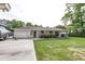 Expansive backyard view with a covered porch, a well-maintained lawn, and a privacy fence at 203 Red Fox Run, Summerville, SC 29485