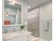 Bright bathroom featuring a marble vanity, modern faucet, and a glass-enclosed tiled shower at 203 Red Fox Run, Summerville, SC 29485