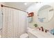 Classic bathroom with a modern vanity, circular mirror, and a shower with patterned curtain at 203 Red Fox Run, Summerville, SC 29485