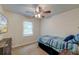 Cozy bedroom with a ceiling fan, wood accent wall, and a flat screen television at 203 Red Fox Run, Summerville, SC 29485