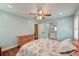 Well-lit bedroom boasts ample natural light, hardwood flooring, and ensuite bathroom at 203 Red Fox Run, Summerville, SC 29485