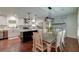Bright dining area with modern lighting, stone fireplace, and an open concept kitchen at 203 Red Fox Run, Summerville, SC 29485