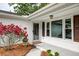 Inviting front porch featuring a brick exterior, roses, and a stylish entrance at 203 Red Fox Run, Summerville, SC 29485