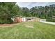 Well-maintained front yard showcasing a charming home with lush landscaping and a driveway at 203 Red Fox Run, Summerville, SC 29485