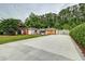 Charming ranch-style home with a wide concrete driveway and mature landscaping at 203 Red Fox Run, Summerville, SC 29485
