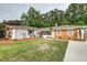 Charming single-story home with a manicured lawn, brick and wood exterior, and mature trees at 203 Red Fox Run, Summerville, SC 29485