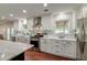 Bright kitchen with white cabinets, marble countertops, and stainless steel appliances at 203 Red Fox Run, Summerville, SC 29485