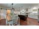 Open kitchen and dining area featuring a large island with seating and stainless steel appliances at 203 Red Fox Run, Summerville, SC 29485