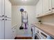 Convenient laundry room with plenty of storage and countertop space for folding at 203 Red Fox Run, Summerville, SC 29485