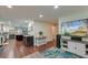 Open concept living room featuring wood floors, a fireplace, and a view into the modern kitchen at 203 Red Fox Run, Summerville, SC 29485