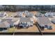 An aerial shot shows homes with fenced yards in a suburban neighborhood with mature trees and a pond at 2064 Parish House Cir, Johns Island, SC 29455