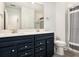Bathroom features a dual sink vanity with dark blue cabinets and a large mirror at 2064 Parish House Cir, Johns Island, SC 29455