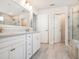 Bright bathroom featuring a large double vanity, a walk-in shower, and neutral tile at 2064 Parish House Cir, Johns Island, SC 29455