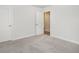 Neutral carpeted bedroom with light grey walls showing entry to adjacent room at 2064 Parish House Cir, Johns Island, SC 29455