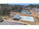 An aerial shot shows the community pool, playground, and clubhouse with parking in a manicured area at 2064 Parish House Cir, Johns Island, SC 29455