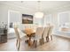 Elegant dining room featuring a modern chandelier, a wooden table, and plenty of natural light at 2064 Parish House Cir, Johns Island, SC 29455