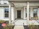 Charming front porch with seating, a security system, and a well-lit entryway for added safety and appeal at 2064 Parish House Cir, Johns Island, SC 29455