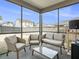 Screened-in patio with comfortable seating arrangement and a glass table at 2064 Parish House Cir, Johns Island, SC 29455
