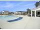 Community pool with ample seating, sunning deck, and bright blue sky at 2064 Parish House Cir, Johns Island, SC 29455