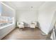 Sitting room with two stylish chairs, a window, and wood-look flooring at 2064 Parish House Cir, Johns Island, SC 29455