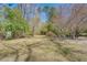 Expansive backyard featuring a storage shed and natural surroundings with mature trees at 2138 Clayton St, Charleston, SC 29414