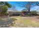 Spacious backyard with screened porch, brick home, and mature trees on a sunny day at 2138 Clayton St, Charleston, SC 29414