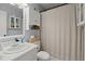 Cozy bathroom featuring a vanity, mirror, toilet, built-in cabinet, and neutral shower curtain at 2138 Clayton St, Charleston, SC 29414