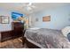 Cozy bedroom features blue walls, a ceiling fan, two windows, and wood flooring with rugs at 2138 Clayton St, Charleston, SC 29414
