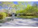 Charming single-story home with a well-manicured front yard, long driveway, and mature shade trees at 2138 Clayton St, Charleston, SC 29414