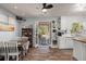 Well-lit kitchen with wooden floors, white cabinets, and an open door to the deck area at 2138 Clayton St, Charleston, SC 29414
