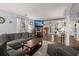 Open-concept living room with stylish decor, a gray sectional, and seamless flow to the kitchen at 2138 Clayton St, Charleston, SC 29414