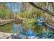 Backyard pond featuring a small waterfall and natural landscaping, creating a serene setting at 2138 Clayton St, Charleston, SC 29414
