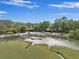 Aerial view of a marina offering convenient boat storage and water access surrounded by lush greenery and trees at 2206 Weepoolow Trl, Charleston, SC 29407