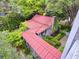 Aerial view of home with red roof and lush greenery and landscape. Walkway to a smaller building at 2206 Weepoolow Trl, Charleston, SC 29407