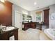 Bathroom showcasing a tub, dark wood vanity, granite countertops, and neutral carpet flooring at 2206 Weepoolow Trl, Charleston, SC 29407