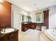 Bathroom featuring a soaking tub, granite countertops, and custom cabinets creating a spa-like ambiance at 2206 Weepoolow Trl, Charleston, SC 29407