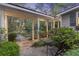 Charming courtyard with a small table and chair surrounded by lush greenery and landscaping at 2206 Weepoolow Trl, Charleston, SC 29407
