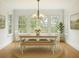 Bright dining room with large windows, table, chairs and bench creating an inviting space for meals at 2206 Weepoolow Trl, Charleston, SC 29407