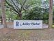 Ashley Harbor entrance sign offers a glimpse of the upscale community's charm and natural surroundings at 2206 Weepoolow Trl, Charleston, SC 29407