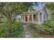 Cozy home with a welcoming front porch, surrounded by lush landscaping and a charming walkway at 2206 Weepoolow Trl, Charleston, SC 29407