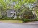 Beautiful two-story home with double porches surrounded by lush greenery, showcasing Southern charm at 2206 Weepoolow Trl, Charleston, SC 29407