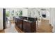 Bright kitchen with a large center island, hardwood floors, and an open layout to the living and dining areas at 2206 Weepoolow Trl, Charleston, SC 29407
