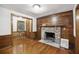 Spacious living room with wood-paneled walls, fireplace, and ample natural light at 2206 Weepoolow Trl, Charleston, SC 29407