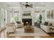 Bright living room with coffered ceiling, fireplace, and hardwood floors, perfect for gatherings at 2206 Weepoolow Trl, Charleston, SC 29407