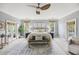 Spacious main bedroom with a ceiling fan, light gray walls, and multiple windows with natural light at 2206 Weepoolow Trl, Charleston, SC 29407